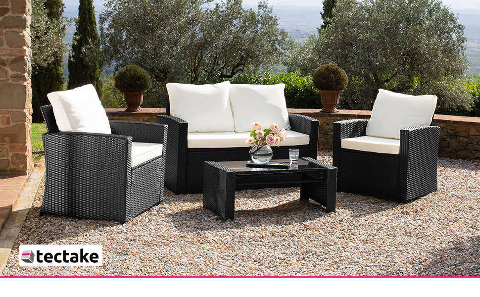 comprenant un canapé, des chaises et une table basse avec coussins blancs. Cadre de jardin avec des arbres en arrière-plan.