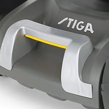 Text reads 'STIGA'. Close-up detail of a gray equipment handle with ergonomic grip features and yellow accent elements.